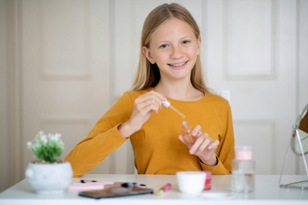 Smiling Teen Girl Applying Face Serum At Home