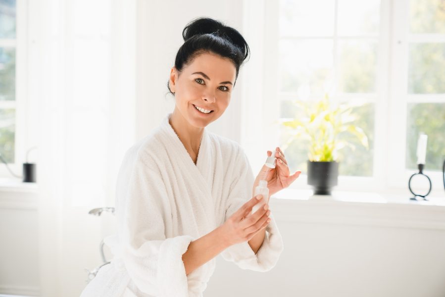 Rejuvenation serum for face skin care. Anti-age anti-wrinkle effect. Mature middle-aged woman in spa